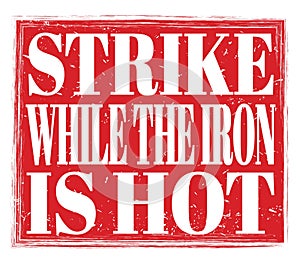STRIKE WHILE THE IRON IS HOT, text on red stamp sign