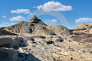 Striking black pyramid and pinnacle tower above the badlands