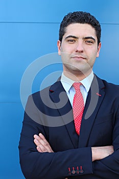 Striking businessman with neutral expression with arms crossed