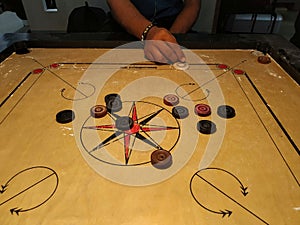 Striking the coins by striker on carrom board