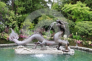 A striking fountain made of granite and bronze, in the form of a dragon in the Butchart Garden