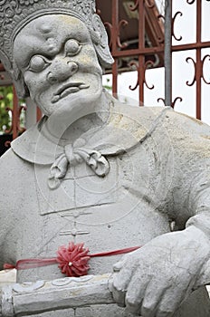 Striking statue of a man in the Wat Arun temple in Bangkok, Thailand