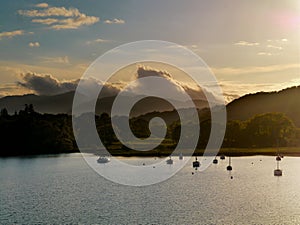 Striking sunset over lake with boats