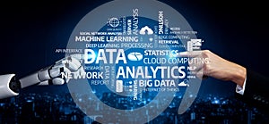Human and robotic interaction showcasing data analysis, machine learning, cloud computing, and analytics concepts in