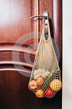 String bag with various fresh vegetables close-up