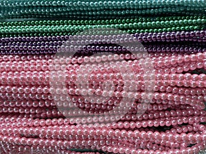 String of beads in various colors. yellow red, blue, green. Colorful beaded necklace for background design