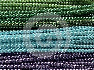 String of beads in various colors. yellow red, blue, green. Colorful beaded necklace for background design