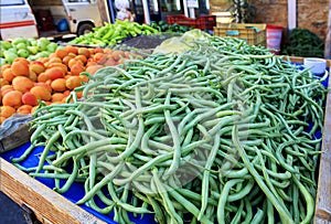 String beans, asparagus, apricots, pears, peppers, plums are sold on the counter