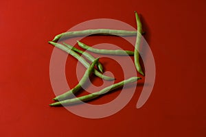 String beans fresh vegetables on isolated red background