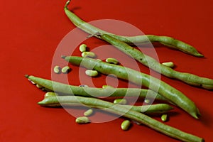 String beans seeds closeup on isolated red background