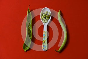 String beans seeds closeup on isolated red background