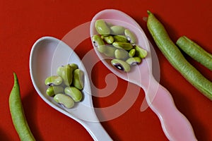 String beans seeds closeup on isolated red background