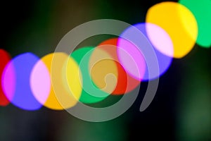 String of blurred multicolored holiday lights