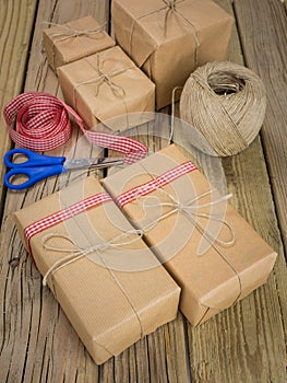 String and brown paper parcels with scissors, ribbon and string