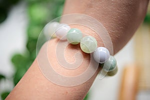 A string of jade beads wearring on wrist