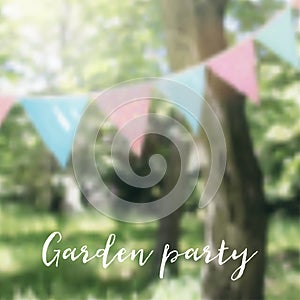 String of pastel bunting flags hanging among trees. Summer birthday garden party decoration. Brazilian June party, Festa