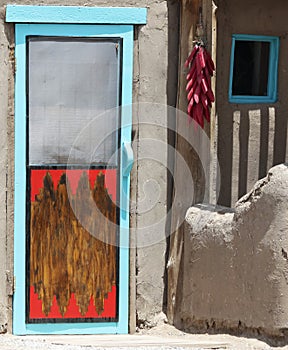 A String of Peppers Hung Outside a Pueblo Door