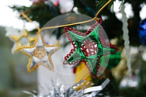 String of stars - christmas decorations hanging on a christmas tree