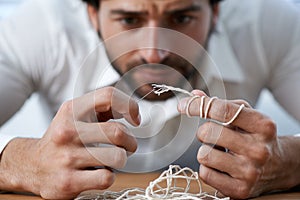 String, thread and man with eye of needle for stitching, sewing and needlework in fashion industry. Struggle