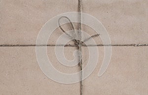 String tied in a bow on a brown recycled paper