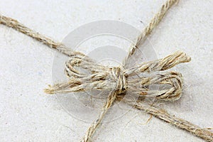 String tied in a bow brown recycled paper