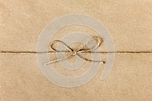 String or twine tied in a bow on kraft paper