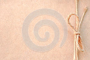 String or twine tied in a bow on kraft paper