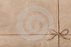 String or twine tied in a bow on kraft paper photo