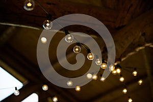 String of White and Yellow Lights Hanging in a Barn