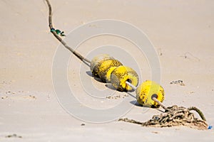 A string of yellow buoys on the beach for safety zoning in the sea.Thailand