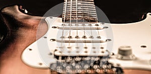 Stringed electric musical instrument. Musical instrument for rock, blues, metal songs. Guitar strings, close up