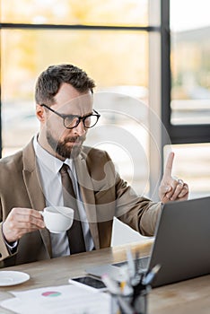 stringent bearded corporate manager in stylish photo