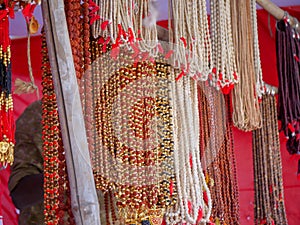 Strings of beads jewellery selling in street shop market. Artificial jewellery string of beads