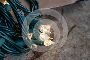 Strings of christmas lights hanging down ready to decorate a home