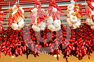 Strings of dried red peppers and garlic.