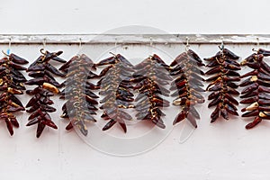 Strings of Espelette peppers drying