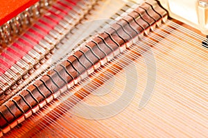 Strings, mallets, dampeners and sound board inside grand piano