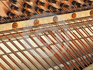 Strings and mechanics of a desolate old weathered piano