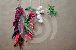 Strings of peppers , chilies , garlic