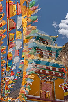 Strings of prayer flags and a monastery