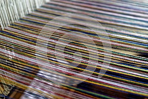 Strings of warp threads in weaving loom close-up