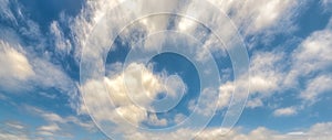 Stringy, wispy clouds in blue sky, panorama format