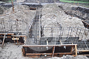 Strip footing, foundation construction. A close-up of a strip house foundation with a dug trench, wood frame and reinforcement