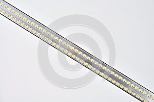 Strip LED light with aluminum profile on white stretch ceiling, modern construction, close up