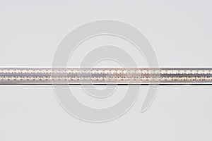 Strip LED light with aluminum profile on white stretch ceiling, modern construction, close up