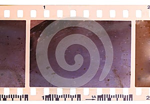 Strip of old, worn and bad developed color celluloid film photo