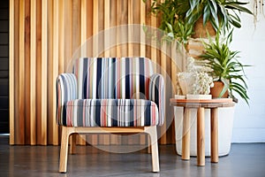 striped accent chair beside a bamboo plant