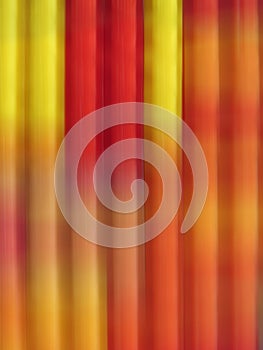 Striped background in vertical motion blured lines in red and yellow photo