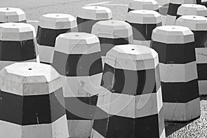 Striped black and white concrete anti-parking cones for roadworks