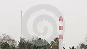 Striped boiler tube smokes into the sky in the winter